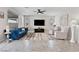 Bright living room with neutral walls, tile floors, ceiling fan, large windows and a blue sofa at 4531 S Bay Tree Ct, Pahrump, NV 89061