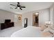 Bright main bedroom with carpet, ceiling fan, a large dresser and access to ensuite bathroom at 4531 S Bay Tree Ct, Pahrump, NV 89061