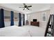 Bedroom featuring carpet, ceiling fan, curtains, and a dresser with mounted TV for entertainment at 4531 S Bay Tree Ct, Pahrump, NV 89061