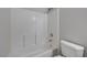 Bright bathroom with white tiled shower-tub combo and modern fixtures at 4716 Cohiba Way, North Las Vegas, NV 89031