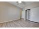 This bedroom has wood-look flooring, a large closet, and neutral walls offering a calming space at 4716 Cohiba Way, North Las Vegas, NV 89031