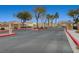 Gated community entrance with lush landscaping and well-maintained street at 4716 Cohiba Way, North Las Vegas, NV 89031