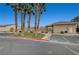 Image of community pool and adjacent parking area with palm trees on a clear, sunny day at 4716 Cohiba Way, North Las Vegas, NV 89031