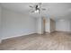 Spacious living room with wood-look flooring, a ceiling fan, and neutral color palette throughout at 4716 Cohiba Way, North Las Vegas, NV 89031