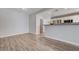 Spacious living room with wood floors, and a breakfast bar overlooking the stainless steel appliances at 4716 Cohiba Way, North Las Vegas, NV 89031