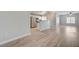 Inviting, open floor plan with wood flooring, connecting the kitchen and living spaces at 4716 Cohiba Way, North Las Vegas, NV 89031