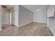 Spacious living room with wood-look flooring and bright, neutral walls at 4716 Cohiba Way, North Las Vegas, NV 89031