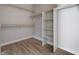 Spacious walk-in closet with shelves and rods for ample storage; well-organized for convenience at 4716 Cohiba Way, North Las Vegas, NV 89031