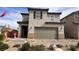 Charming two-story home featuring a two car garage, neutral stucco facade, and inviting landscape at 5151 Capucina St # Lot 1, Las Vegas, NV 89122