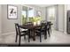 Well-lit dining room featuring a sleek, dark wood table set, perfect for Gathering meals and entertaining guests at 5151 Capucina St # Lot 1, Las Vegas, NV 89122