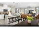 Open-concept living space showcasing a stylish kitchen island, dining area, and inviting living room setup at 5151 Capucina St # Lot 1, Las Vegas, NV 89122