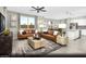 Sun-filled living room with modern decor, plush seating, and an open layout to the kitchen and dining area at 5151 Capucina St # Lot 1, Las Vegas, NV 89122