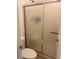 Bathroom with frosted glass shower doors, a toilet, and neutral decor at 5158 S Jones Blvd # 105, Las Vegas, NV 89118