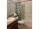 Bathroom featuring a tiled floor, granite countertop, toilet, and shower-tub combo at 5158 S Jones Blvd # 105, Las Vegas, NV 89118