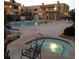 Community pool and hot tub area with lounge chairs and decorative geese statues at 5158 S Jones Blvd # 105, Las Vegas, NV 89118