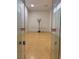 A clean and well-lit racquetball court featuring clear glass doors, hardwood floors, and a regulation-sized backboard at 5158 S Jones Blvd # 105, Las Vegas, NV 89118