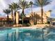 Relaxing community swimming pool surrounded by lush palm trees, lounge chairs, and building, offering a serene oasis at 5158 S Jones Blvd # 105, Las Vegas, NV 89118