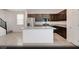 Modern kitchen features a large island, stainless steel appliances, and dark wood cabinetry for culinary enthusiasts at 5169 Capucina St # Lot 4, Las Vegas, NV 89122