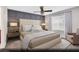 Relaxing main bedroom features a plush upholstered headboard, neutral color scheme, and a ceiling fan at 5169 Capucina St # Lot 4, Las Vegas, NV 89122