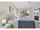 Serene bedroom featuring a comfortable bed, natural lighting, and wood flooring at 5235 Caspian Springs St # 101, Las Vegas, NV 89120