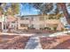 Attractive condo building showing manicured landscaping, second story balconies, and exterior stairs at 5235 Caspian Springs St # 101, Las Vegas, NV 89120