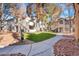 Exterior of condo complex featuring trees, well kept grassy area, and community landscaping at 5235 Caspian Springs St # 101, Las Vegas, NV 89120