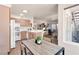 Open concept kitchen with wooden cabinets, stainless steel appliances, and adjacent dining area at 5235 Caspian Springs St # 101, Las Vegas, NV 89120