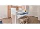 Kitchen with a breakfast bar, white appliances, and hardwood floors at 5235 Caspian Springs St # 101, Las Vegas, NV 89120