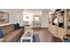 Inviting living room with open floorplan, hardwood floors and breakfast bar seating at 5235 Caspian Springs St # 101, Las Vegas, NV 89120