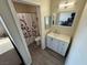 Bathroom featuring a vanity with a mirror and a shower/tub combination with a curtain at 5320 Portavilla Ct # 203, Las Vegas, NV 89122