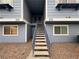 Inviting condo exterior with light blue siding and stairs leading to upper-level units at 5320 Portavilla Ct # 203, Las Vegas, NV 89122