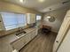 Eat-in kitchen featuring updated countertops, modern lighting and stainless-steel sink at 5320 Portavilla Ct # 203, Las Vegas, NV 89122