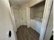 Hallway with a convenient laundry closet featuring a stacked washer and dryer set at 5320 Portavilla Ct # 203, Las Vegas, NV 89122