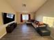 Spacious living room with updated laminate flooring and comfortable seating near a bright window at 5320 Portavilla Ct # 203, Las Vegas, NV 89122