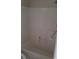 White bathtub with white tiled walls at 5750 E Hacienda Ave # 117, Las Vegas, NV 89122