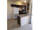 Bright kitchen featuring sleek, modern appliances and dark cabinetry at 5750 E Hacienda Ave # 117, Las Vegas, NV 89122