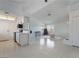 Open living space with bright white walls, tile floors, and large windows, plus adjacent kitchen at 5841 Medallion Dr # 202, Las Vegas, NV 89122