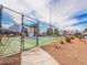 View of the community tennis court, surrounded by a fence and landscaping at 5841 Medallion Dr # 202, Las Vegas, NV 89122