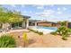 A lush backyard includes a pool, landscaped gravel, and covered patio, perfect for outdoor living at 59 Reflection Bay Dr, Henderson, NV 89011