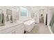 Modern bathroom with a soaking tub, a double vanity and separate shower at 59 Reflection Bay Dr, Henderson, NV 89011