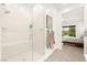 Spa-like bathroom with a glass shower and views into the main bedroom at 59 Reflection Bay Dr, Henderson, NV 89011