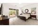 Bright primary bedroom with outdoor patio access and modern furnishings at 59 Reflection Bay Dr, Henderson, NV 89011
