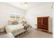 Bright bedroom with a decorative throw blanket and two dressers at 59 Reflection Bay Dr, Henderson, NV 89011