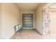 Inviting entryway with double doors, stylish brick flooring, and seating area at 59 Reflection Bay Dr, Henderson, NV 89011