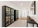 Bright entryway with tiled floors, glass cabinets, and modern decor at 59 Reflection Bay Dr, Henderson, NV 89011