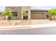Modern home featuring stone accents, desert landscaping, and a contemporary garage door at 59 Reflection Bay Dr, Henderson, NV 89011