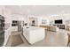 Open kitchen and living space with a large island and ample seating at 59 Reflection Bay Dr, Henderson, NV 89011