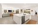 Open-concept kitchen with stainless appliances, island with seating, and seamless flow to the living area at 59 Reflection Bay Dr, Henderson, NV 89011