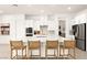 Bright kitchen with an island, counter seating, and stainless steel appliances at 59 Reflection Bay Dr, Henderson, NV 89011
