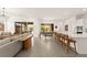 Bright open-concept living room with tile floors, modern lighting, and seamless access to the outdoor patio at 59 Reflection Bay Dr, Henderson, NV 89011